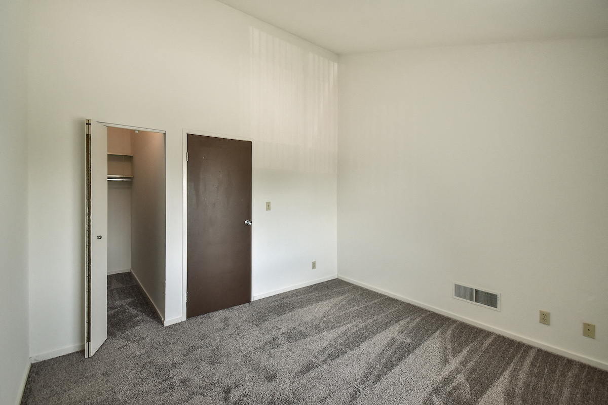 Apartment bedroom with walk-in closet