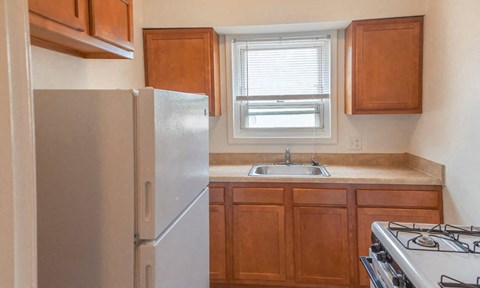 a small kitchen with a refrigerator and a sink