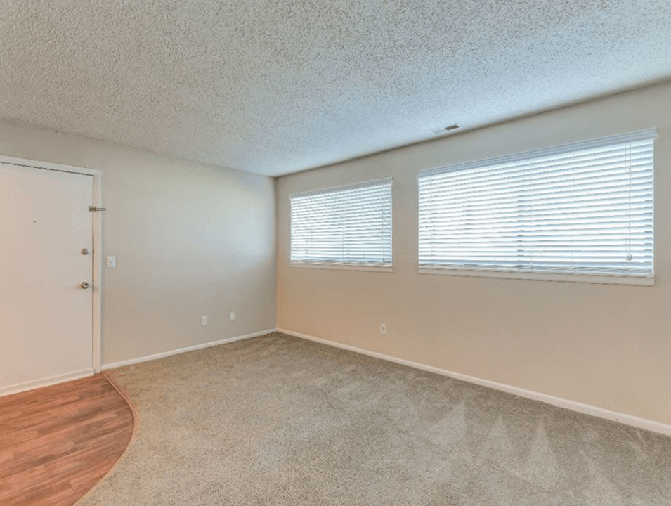 bedroom with windows at The Club at Cherry Hills Apartments