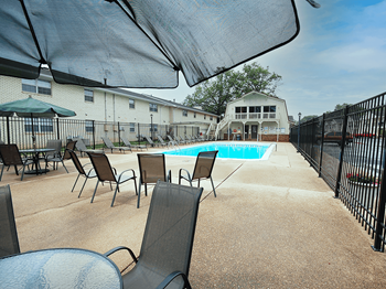 seating area by pool at apartment in evansville - Photo Gallery 5