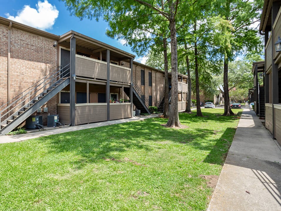 open green area outside of apartments at acadian point