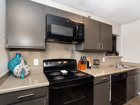 a kitchen with a stove microwave and sink