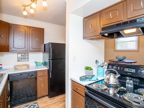 a kitchen with a stove top oven and a refrigerator