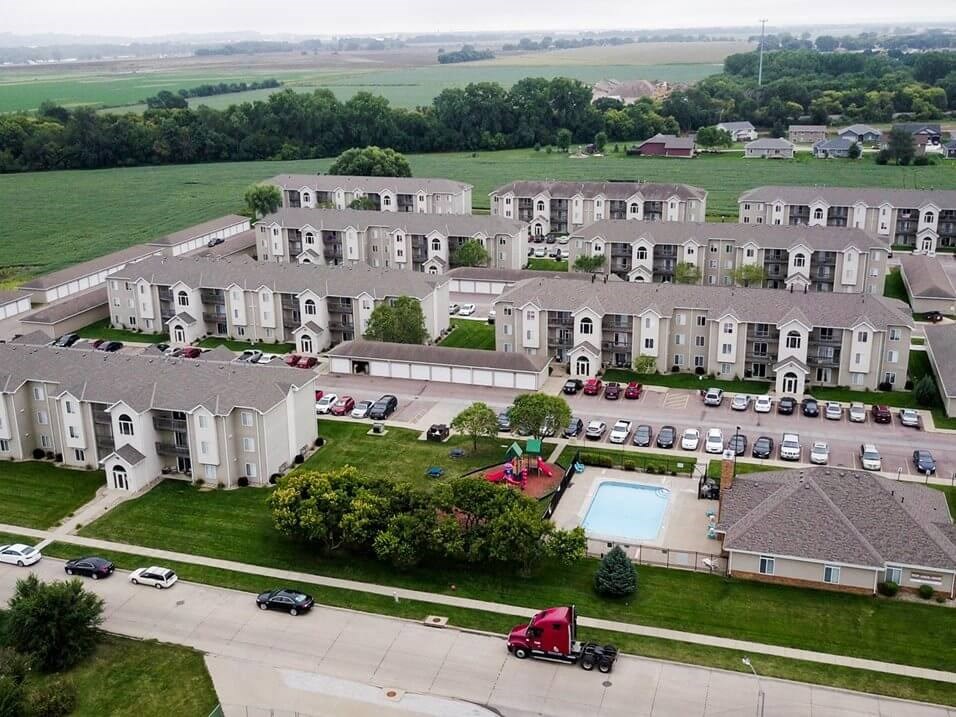 an aerial view of an apartment complex with a pool
