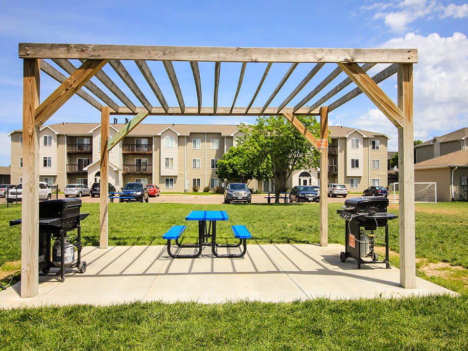 our apartments showcase a clubhouse with a picnic table and grill