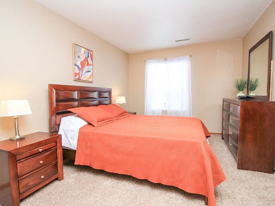 a bedroom with a bed and a dresser