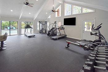 A spacious home gym with a variety of exercise equipment.
