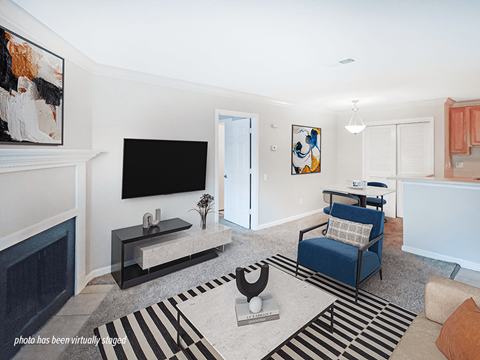 A living room with a blue chair and a television.