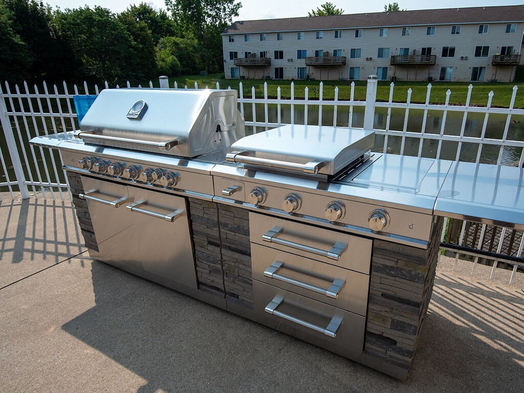 a stainless steel grill and barbecue on a patio