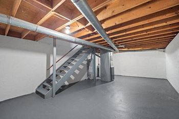 an empty garage with a staircase in it