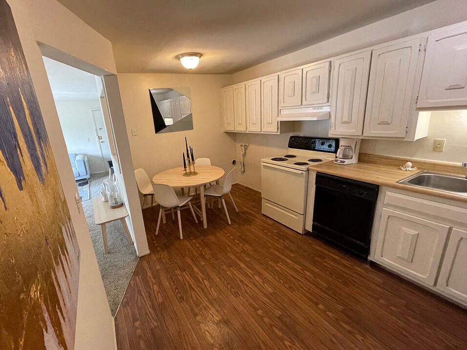 apartment kitchen with wood style flooring