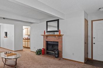 a living room with a fireplace and a table