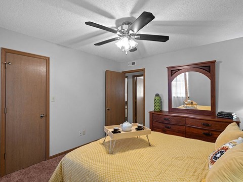 a bedroom with a bed and a ceiling fan