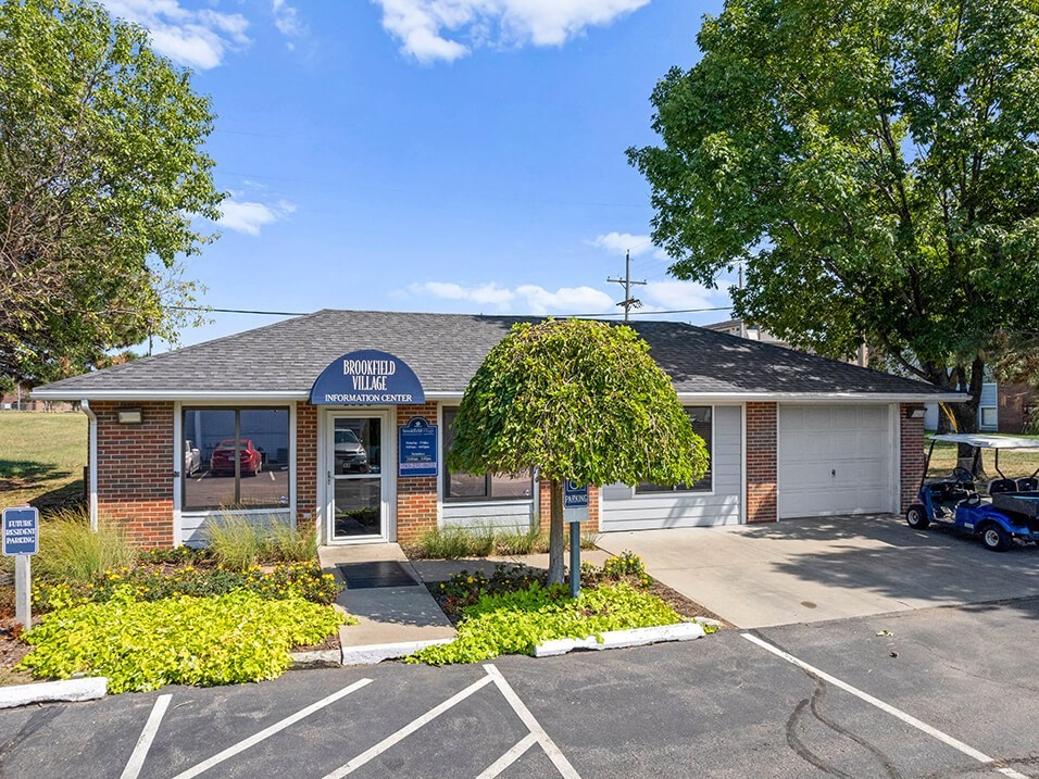 a brick office building with a tree in front of it