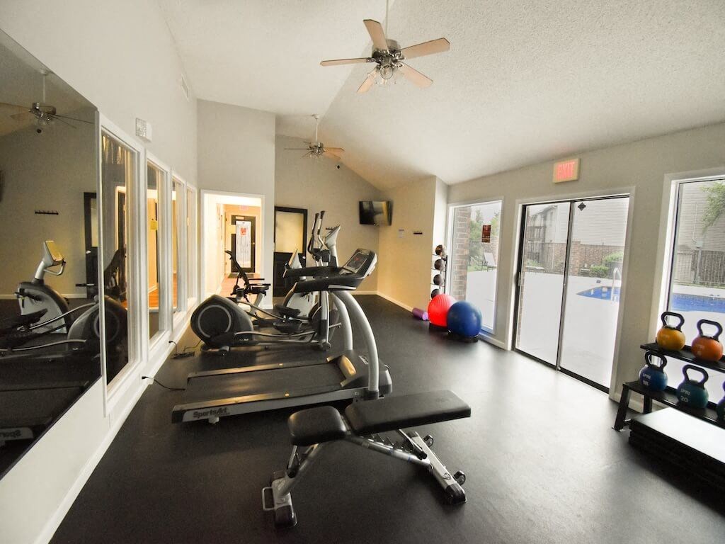 apartment gym with a ceiling fan and exercise equipment