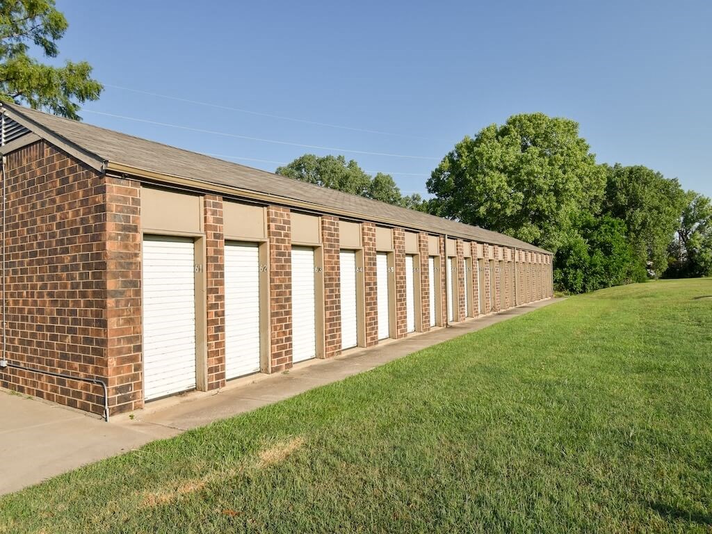 a long brick building with storage units.