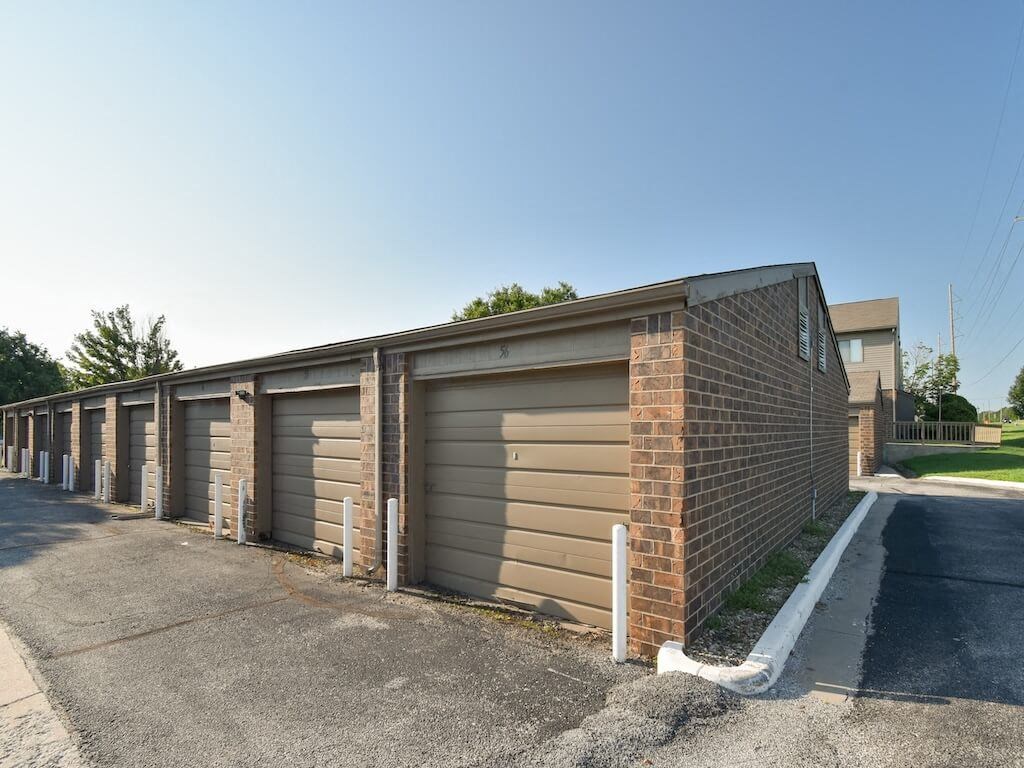 a row of garages on the side of a street