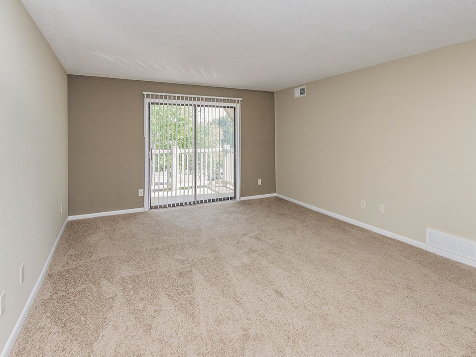 Room with carpeting and balcony access at bavarian woods apartments