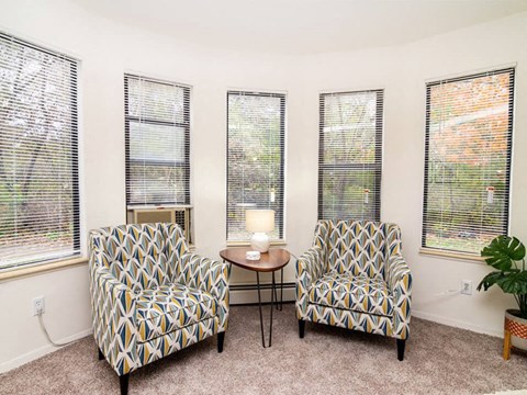 a living room with two chairs and a table