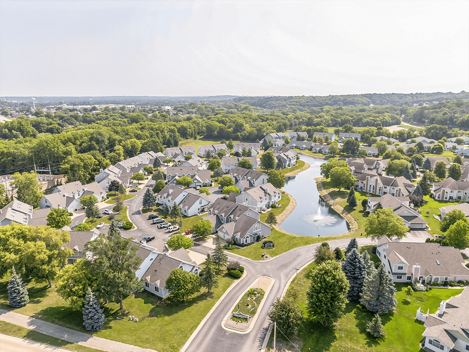 an aerial view of a neighborhood with houses and a river