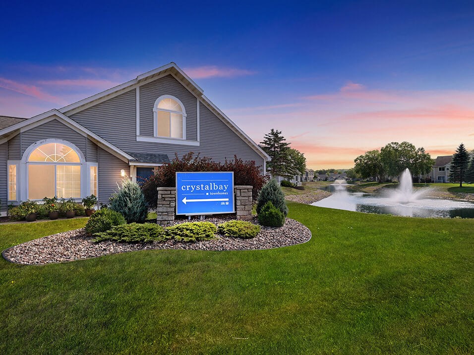 a building with a fountain and a sign in front of it