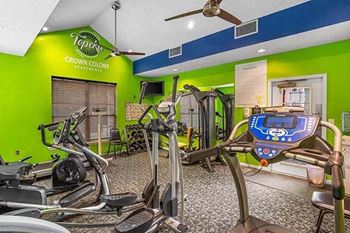 a gym with a bunch of exercise equipment in it