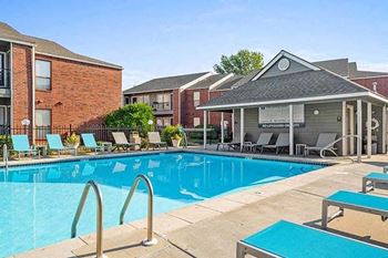 a large swimming pool in front of a building