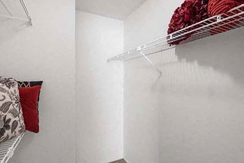 a white closet with a white wall and a wire rack on the wall