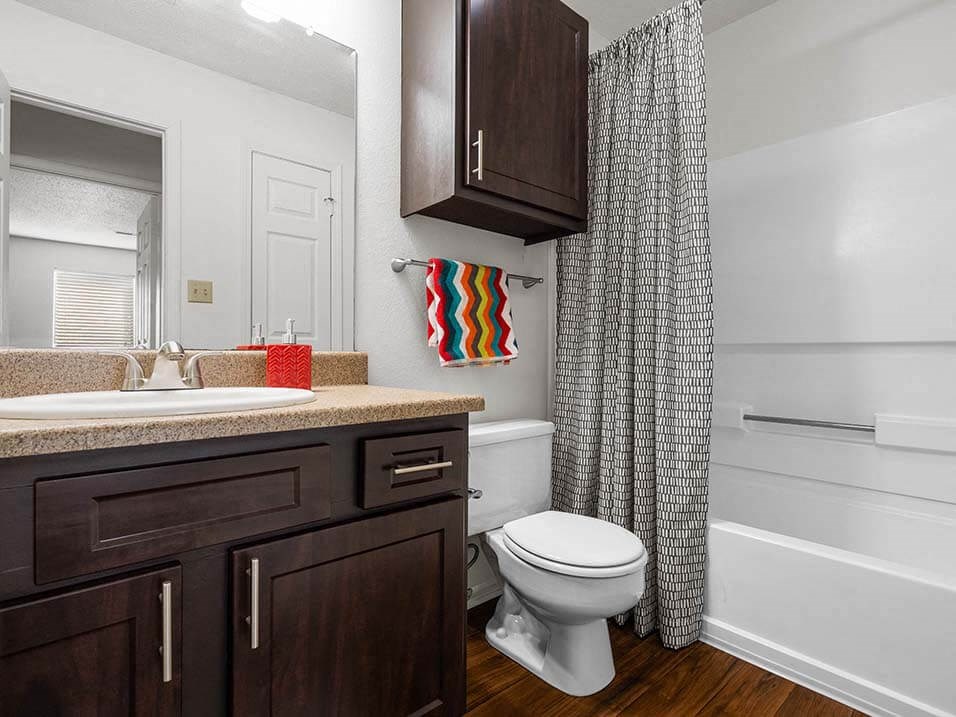 a bathroom with a white toilet and a shower