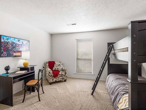 a bedroom with a bunk bed and a desk