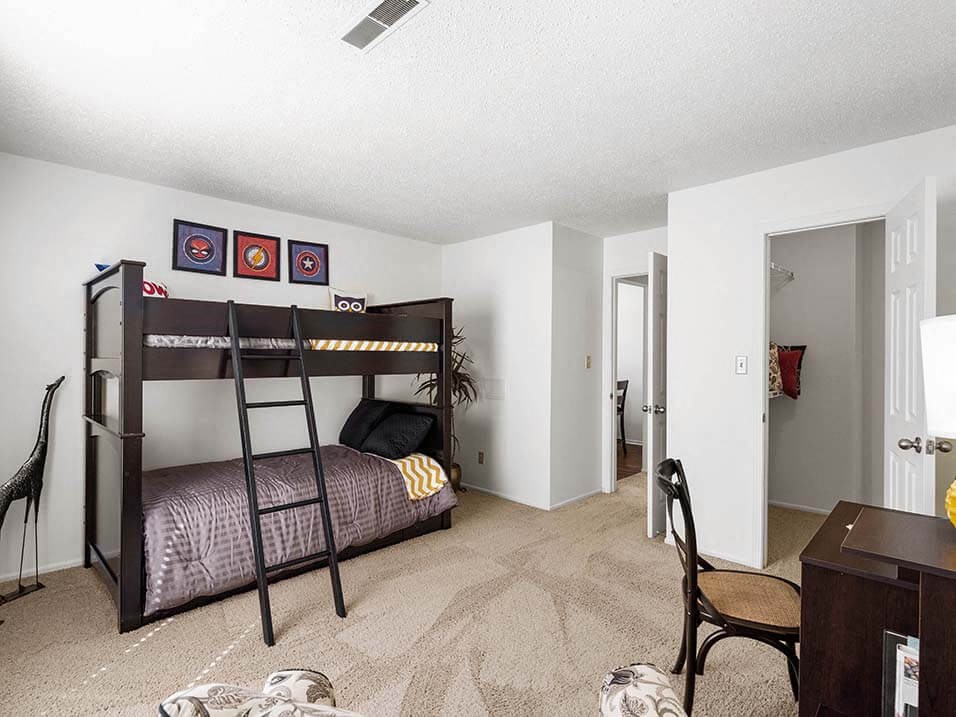 a bedroom with a bunk bed and a desk