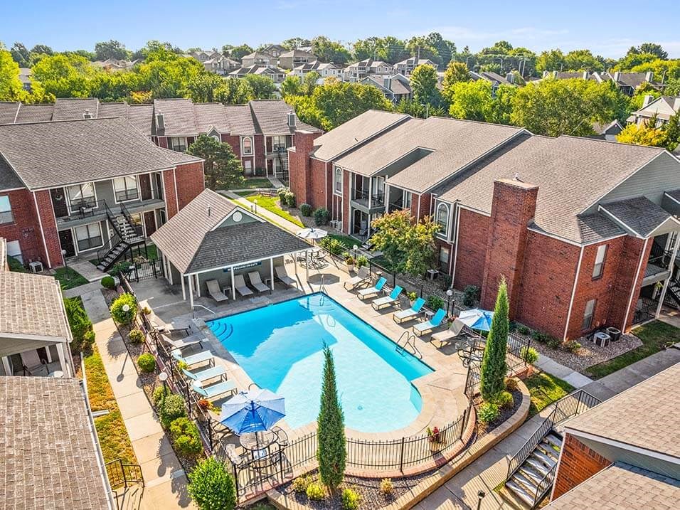 an aerial view of a swimming pool surrounded by apartments