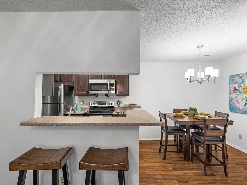 a kitchen with a bar and a dining table