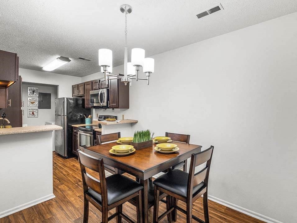an open kitchen and dining room with a table and chairs