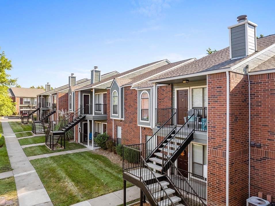 a row of brick apartment buildings with stairs