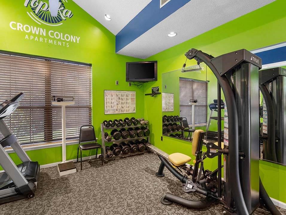a group of people are walking down a building with different colored flags