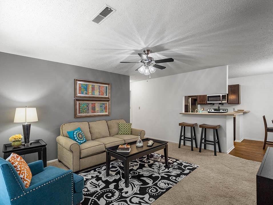 a living room with a couch and a ceiling fan