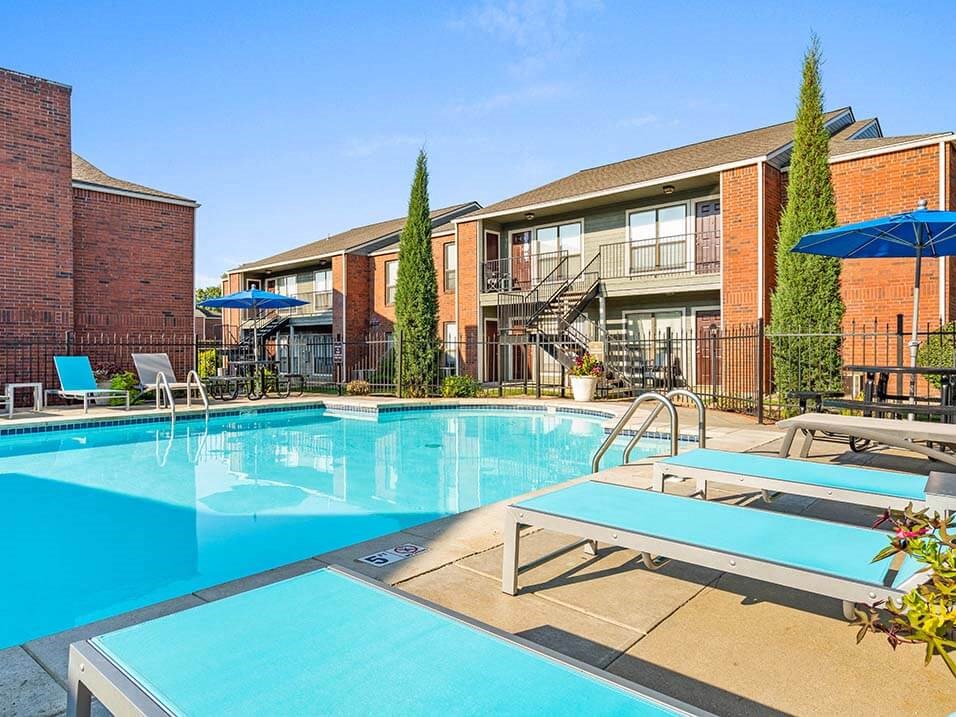 a large swimming pool with some chairs around it