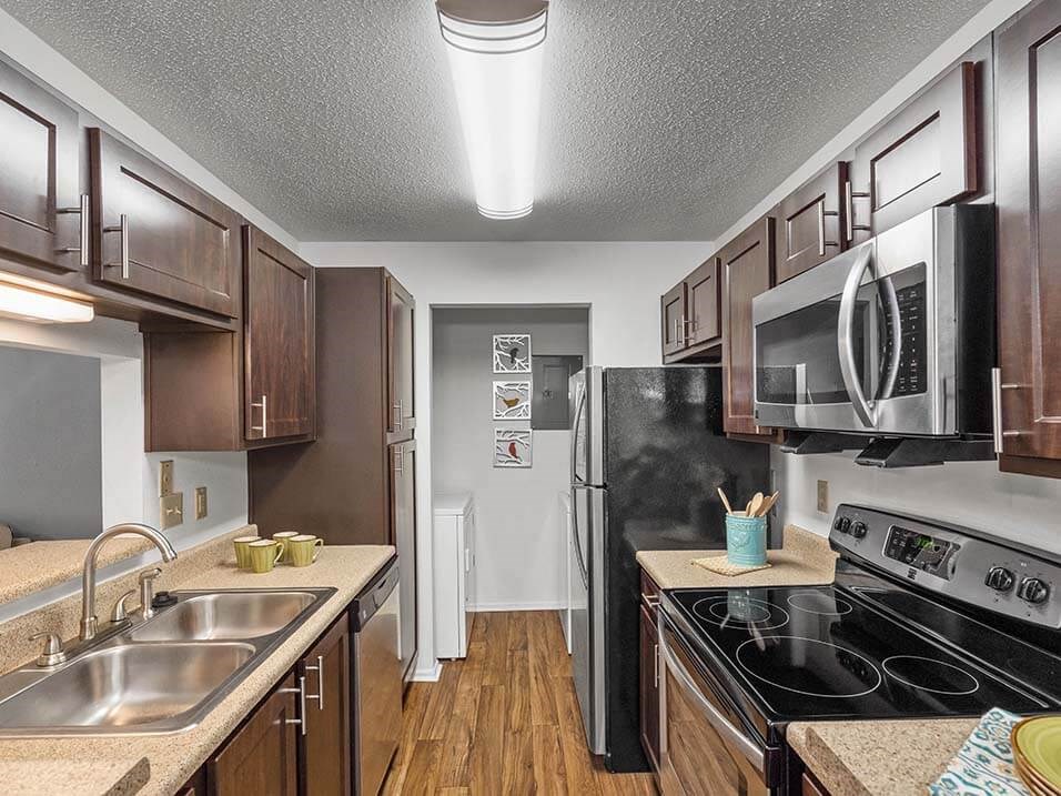 a kitchen with stainless steel appliances and wooden cabinets