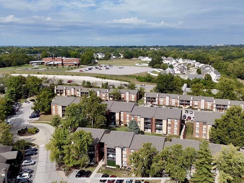 apartment complex with a parking lot