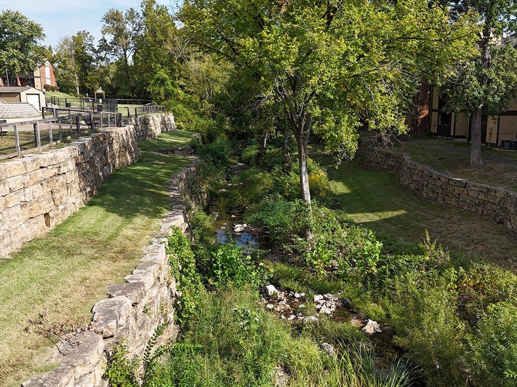 a river running by apartment community