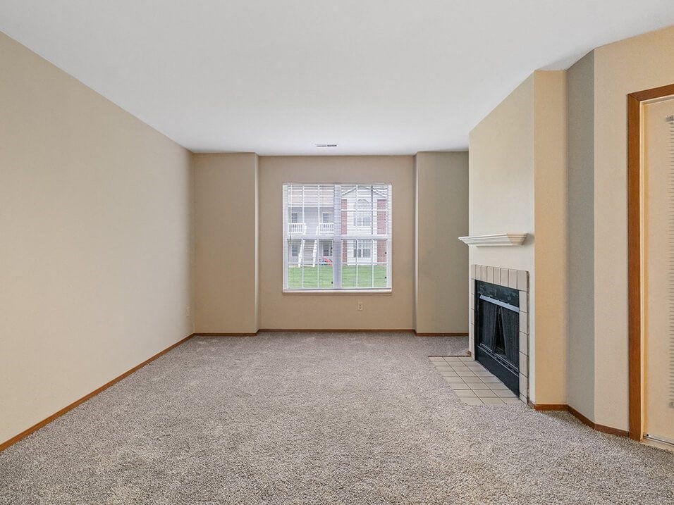 apartment living room with a fireplace and a window