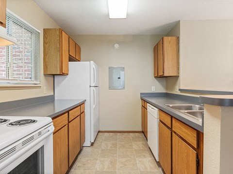 a kitchen with white appliances and wooden cabinets