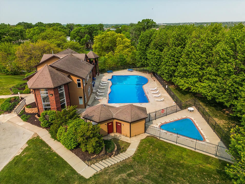 arial view of a house with a large pool in the backyard