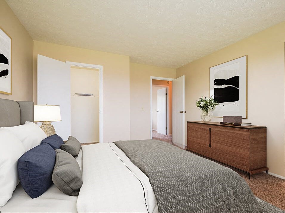 a bedroom with a bed and a dresser