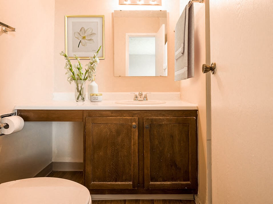 a bathroom with a toilet sink and mirror