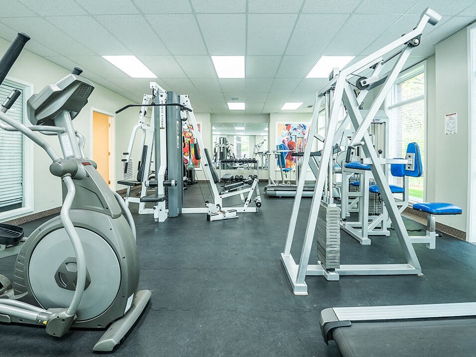 a well equipped gym with cardio equipment and weights