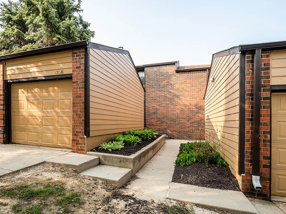 a row of garages with brown doors