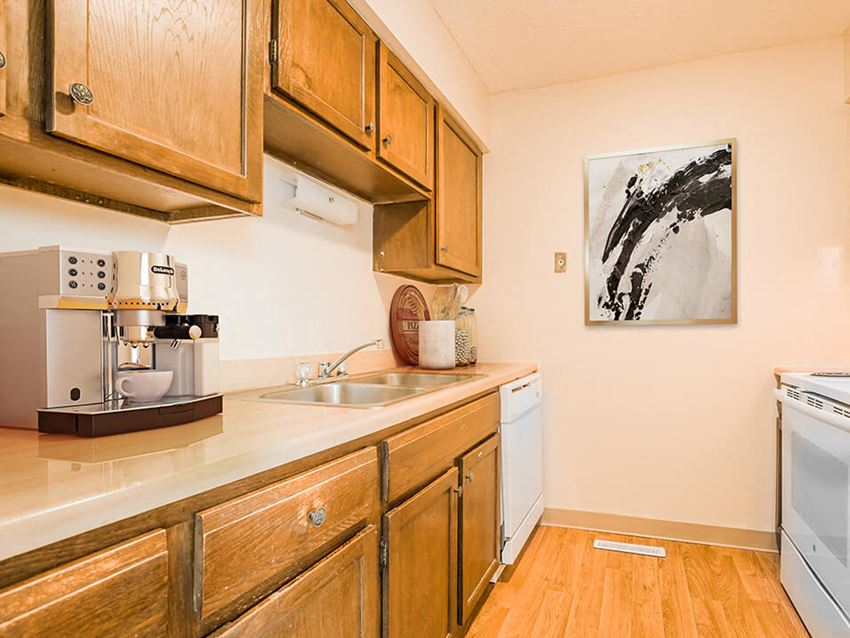 apartment kitchen with wood cabinets and white appliances - Photo Gallery