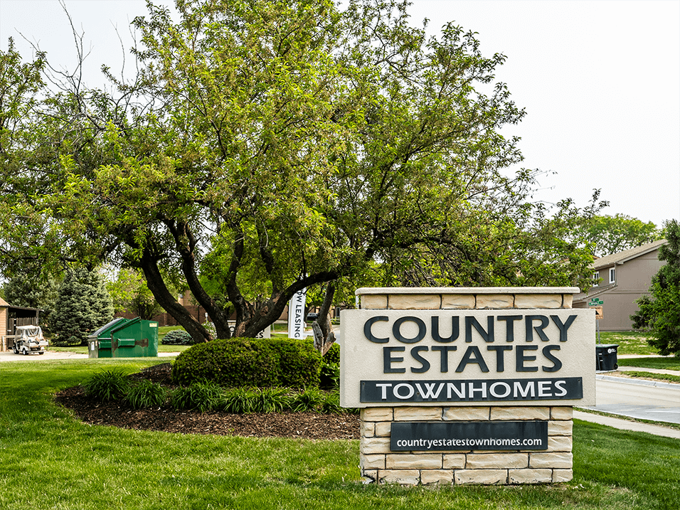 a welcome sign for Country Estates townhomes